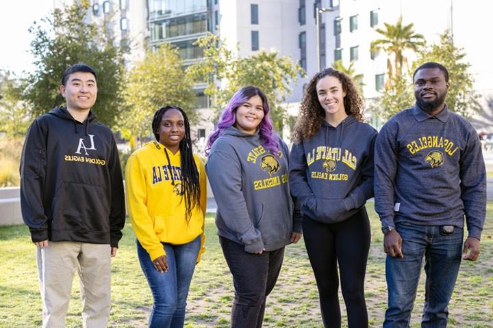 A diverse group of students pose for a photo.